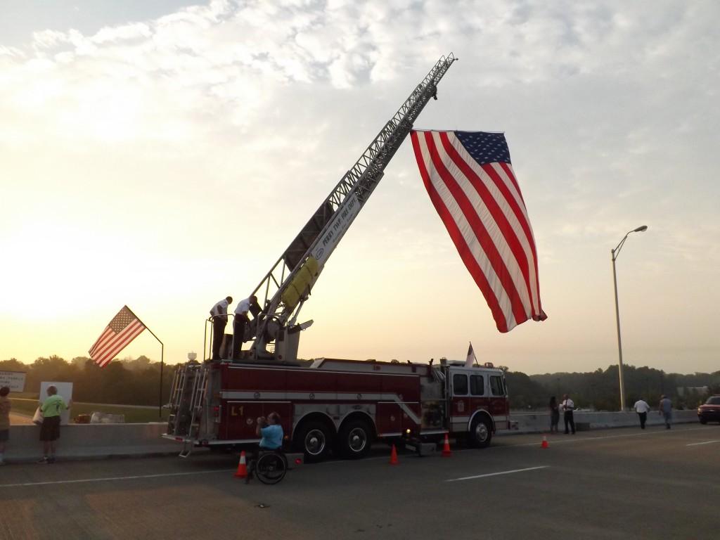 An American flag hangs over the Lloyd Expressway by way of the Perry Township Fire Department Wednesday morning to commemorate Sept. 11, 2001.  By Caleb Riley/The Shield