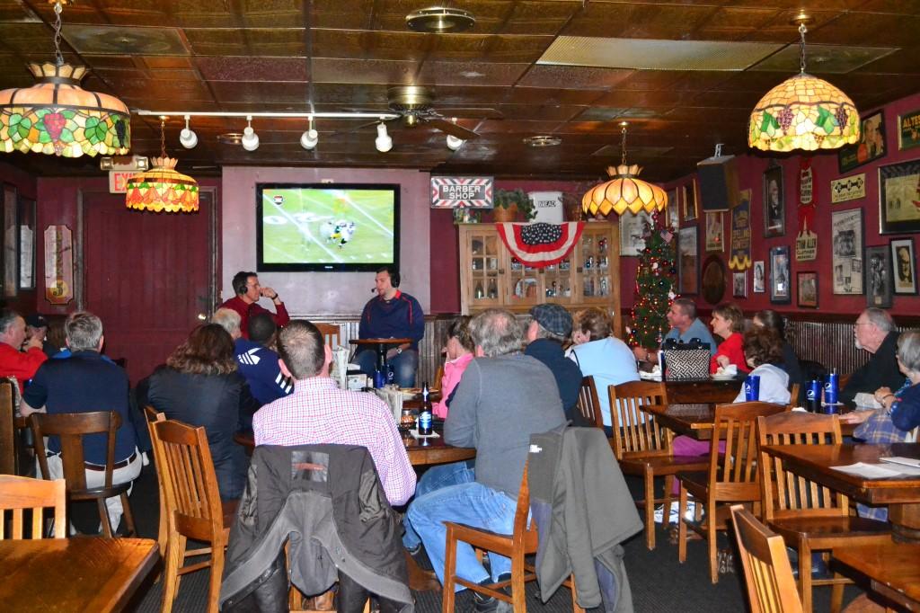Photo by Sarah Loesch/The Shield Radio sportscaster Dan Egierski and assistant men's basketball coach Brent Owen talk about future games in front of a crowded audience Monday night at Turoni's Pizzery & Brewery on Main Street.