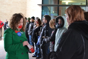 Senior Psychology Major Marian Yoder passes out red tape during a stand-in opposing HJR-6 Friday. 