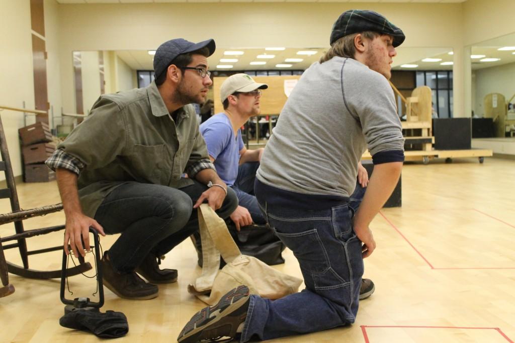 Freshman theatre arts major Conner Keef, playing as Tom Joad, hides out with sophomore theatre arts major Cameron Ward, playing as Jim Casy, and freshman theatre arts major Aaron Newton as they rehearse a scene in the “Grapes of Wrath” which runs Oct. 15-18 in the Performance Center. 