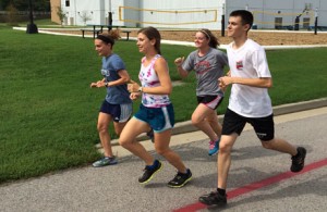 Brynne Doherty, Sara Schamber, Erica Hart and Quade Harvey run on USI's Burdette Trail Monday morning before Labor day activities.