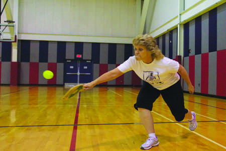 Sherry Tynes, the Information Systems Associate in the USI Foundation office, returns a serve during a game of Pickle Ball during their weekly faculty game Tuesday.