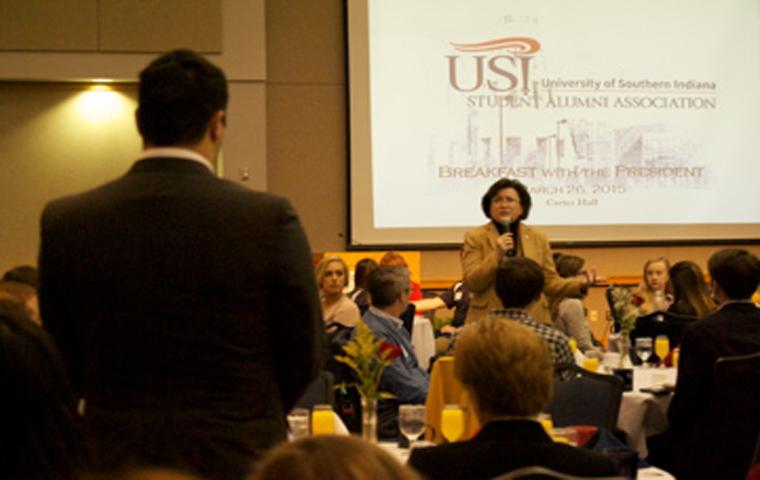 Luke Williams, a senior biology major, asks Linda Bennett about her take on advertisement on campus at the annual breakfast March 27, in Carter Hall.