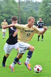 Sophomore defender Josh Weinzapfel dribbles the ball down the field  during the "Gold Game." Photo by JIMMY PYLES/The Shied