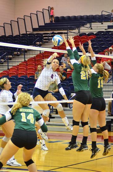 Freshman middle blocker Amy Zwissler spikes the ball.
